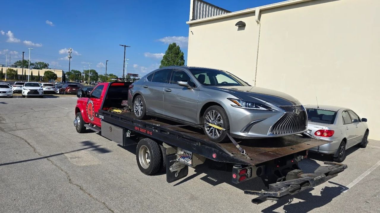 Flatbed tow truck transporting car in Tulsa